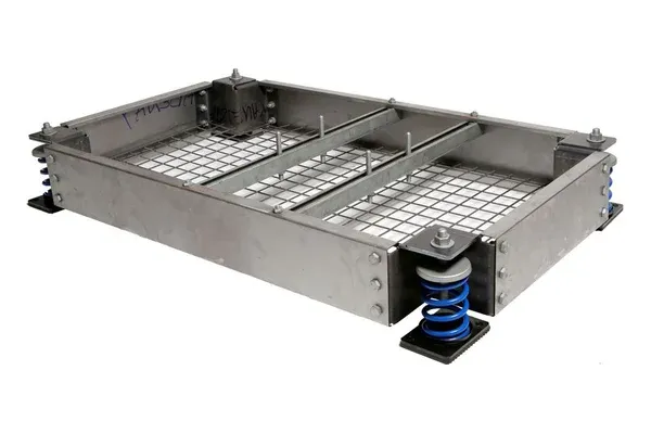 AIB-M modular inertia base: bolted steel perimeter panels with reinforcing mesh and corner brackets on blue open spring isolators