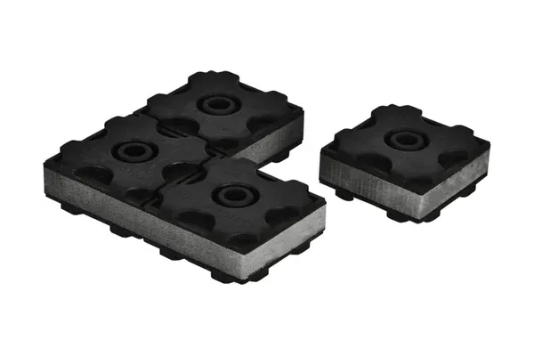 API-MC modular anti-vibration pad bonded to steel plates, with a central bolt hole