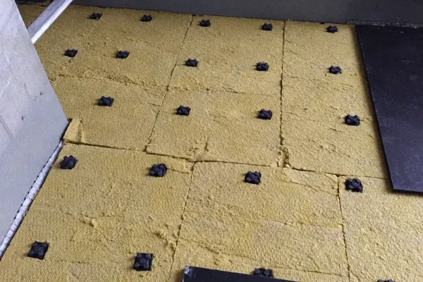 AFR-R floating floor mounts set out on the structural slab, with mineral wool between them