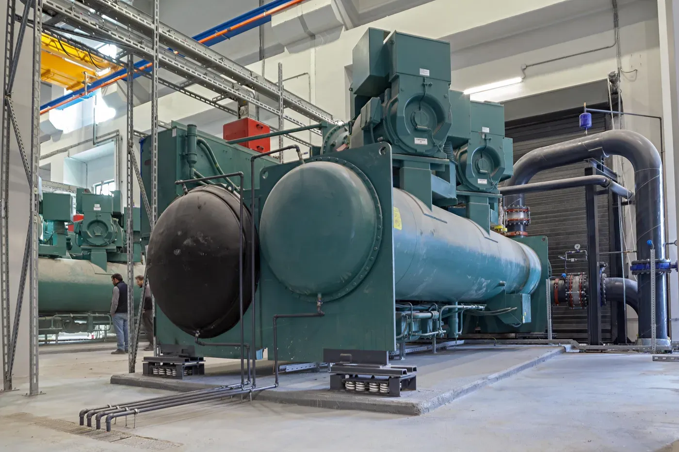 Large water-cooled chillers standing on ASI-T12 heavy-duty spring isolators in a chiller plant room at Istanbul Airport